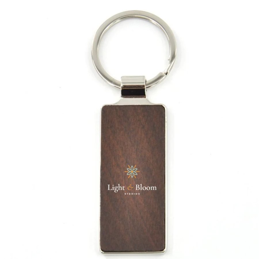 Dark wood keyring personalised with the Light & Bloom logo