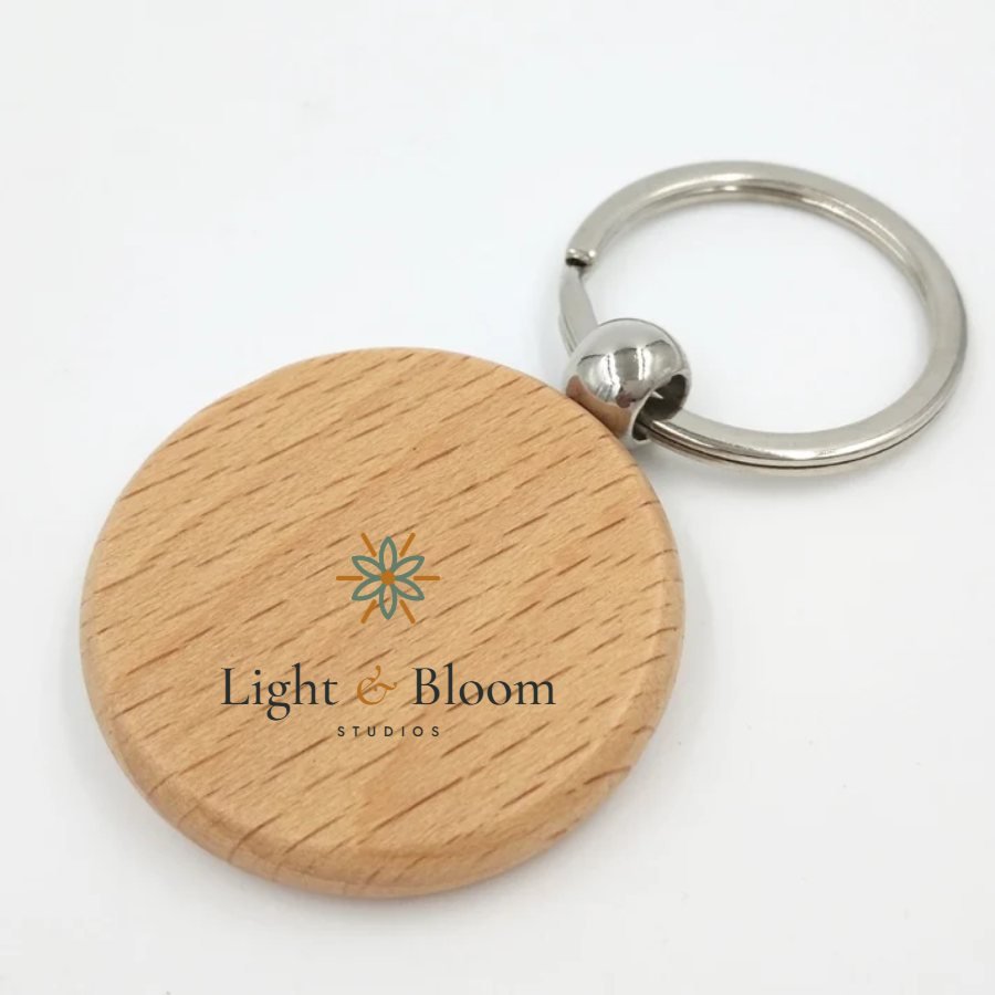 Natural wooden keyring personalised with the Light & Bloom logo